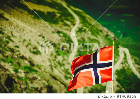 Norwegian flag and Trollstigen mountain road Norwegian flag and Trollstigen mountain road 91469358