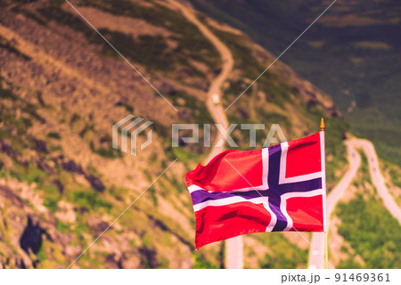 Norwegian flag and Trollstigen mountain road Norwegian flag and Trollstigen mountain road 91469361