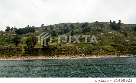 Panoramic view to Taquile island coastline at Titicaca lake, Puno, Peru Panoramic view to Taquile island coastline at Titicaca lake, Puno, Peru 91469922