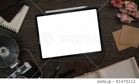 Stylish workspace with digital tablet, retro camera, notebook and sticky notes on wooden table Stylish workspace with digital tablet, retro camera, notebook and sticky notes on wooden table 91470212