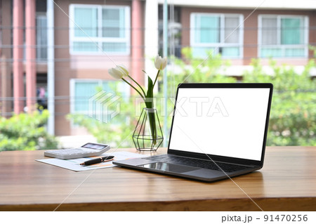 Comfortable workplace with laptop computer, coffee cup and notebook on wooden table 91470256
