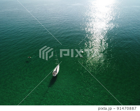 Aerial panoramic view of seascape with crystal clear azure sea and rocky shores. Yachts in a beautiful lagoon on backdrop of rocks. The concept of an ideal destination for summer travel and vacation. Aerial panoramic view of seascape with crystal clear azure sea and rocky shores. Yachts in a beautiful lagoon on backdrop of rocks. The concept of an ideal destination for summer travel and vacation. 91470887