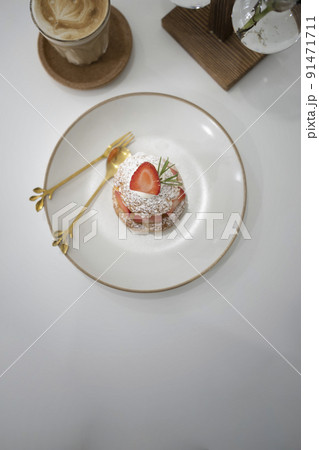 Vanilla choux cream puff with fresh strawberries on white plate. Vanilla choux cream puff with fresh strawberries on white plate. 91471711