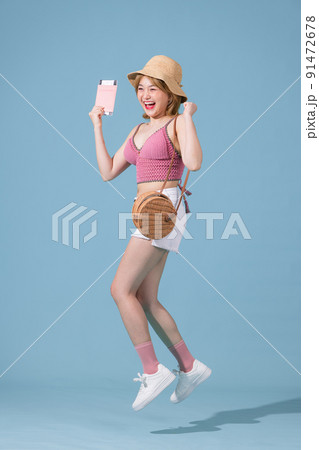 Young traveling girl isolated on blue color background Young traveling girl isolated on blue color background 91472678