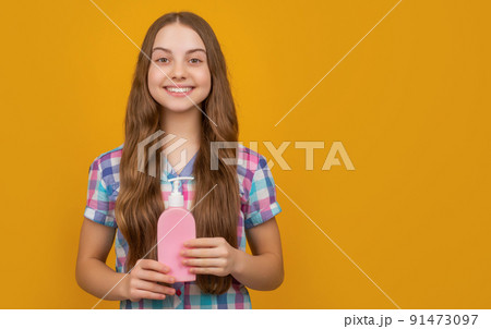 cheerful kid with liquid soap bottle on yellow background cheerful kid with liquid soap bottle on yellow background 91473097