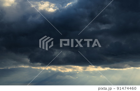 beautiful dramatic sky and sunlight, dark silhouette of clouds as background 91474460