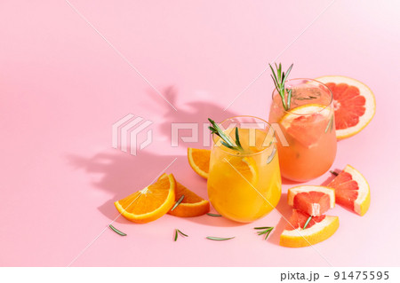 Summer cocktails with grapefruit, orange, rosemary, and ice. 91475595