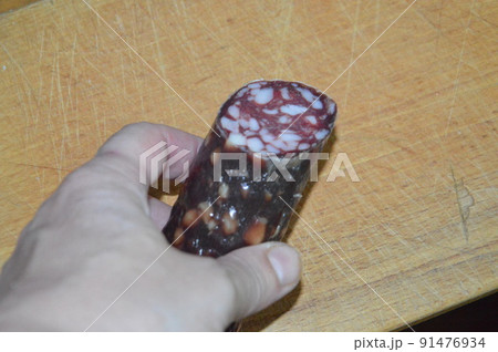 Raw smoked sausage lies on bread like a sandwich 91476934