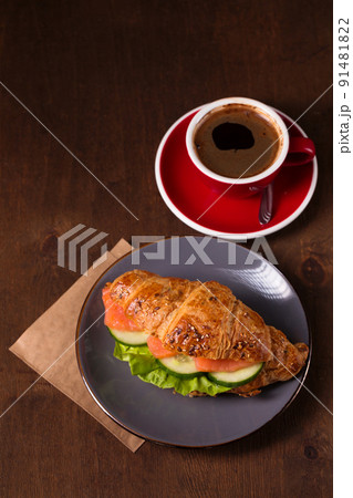 croissant with salmon and espresso, top view 91481822