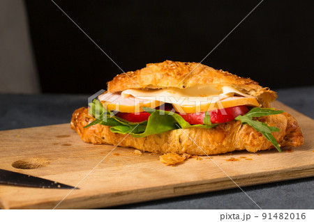 Cooked croissant with ham, cheese and vegetables 91482016