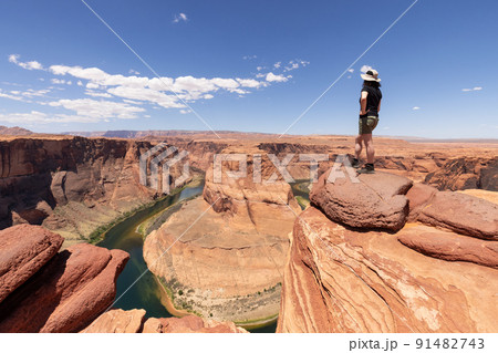 Adventurous Caucasian Woman at Horseshoe Bend in Page, Arizona, United States. Adventurous Caucasian Woman at Horseshoe Bend in Page, Arizona, United States. 91482743