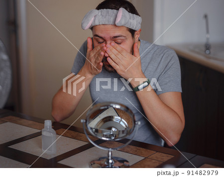 Men's beauty concept. caucAsian guy checking his skin. Men's beauty concept. caucAsian guy checking his skin. 91482979
