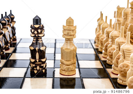 Beige Brown Wooden chess different pieces figures standing on chessboard. Closeup game concept competition, Classic Tournament. Beige Brown Wooden chess different pieces figures standing on chessboard. Closeup game concept competition, Classic Tournament. 91486796