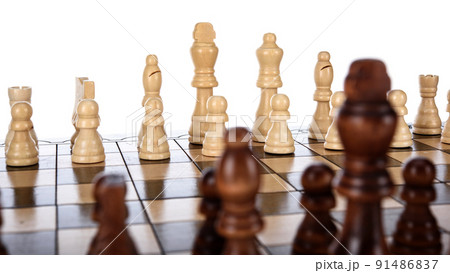 Beige Brown Wooden chess different pieces figures standing on chessboard. Closeup game concept competition, Classic Tournament. Beige Brown Wooden chess different pieces figures standing on chessboard. Closeup game concept competition, Classic Tournament. 91486837