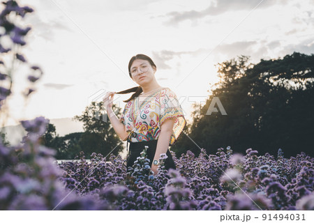 Woman (LGBTQ) posing at flower park garden field 91494031