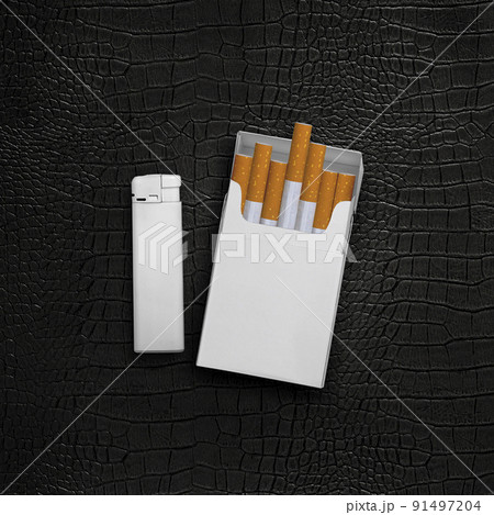 Cigarette pack and lighters on a black leather background 91497204