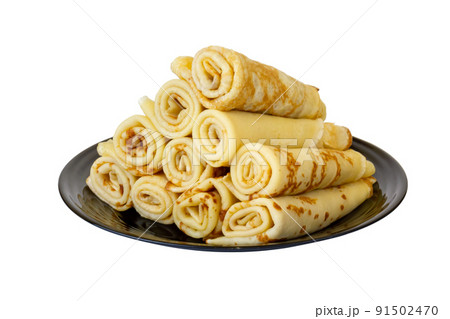 Crepes on a black plate. Isolate on a white background. Crepes on a black plate. Isolate on a white background. 91502470
