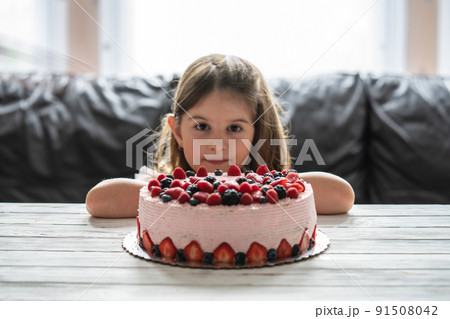 Little girl birthday cake.Home made cake with berries. Cake with Strawberry, blackberry, blueberry, and raspberry on a table Little girl birthday cake.Home made cake with berries. Cake with Strawberry, blackberry, blueberry, and raspberry on a table 91508042