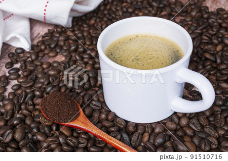 Cup of coffee on coffee beans background. Cup of coffee on coffee beans background. 91510716