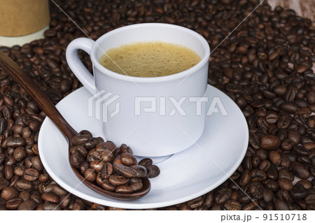 Cup of coffee on coffee beans background. Cup of coffee on coffee beans background. 91510718