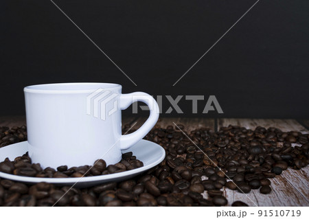 Cup of coffee on coffee beans background. Cup of coffee on coffee beans background. 91510719