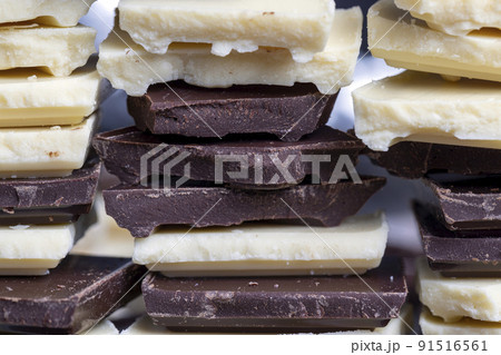 broken into pieces tiles of white and milk and dark chocolate broken into pieces tiles of white and milk and dark chocolate 91516561