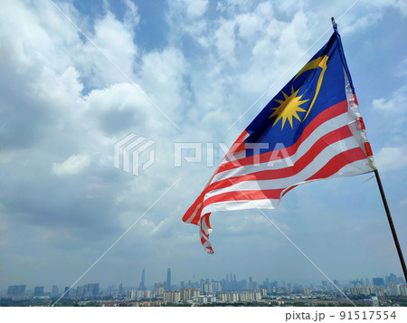 The Malaysian flag aka Jalur Gemilang is flown at a high place and against the backdrop of the Kuala Lumpur skyline The Malaysian flag aka Jalur Gemilang is flown at a high place and against the backdrop of the Kuala Lumpur skyline 91517554