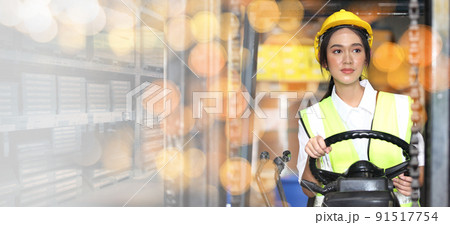 female driving forklift or Woman warehouse worker with forklift.worker in warehouse, Working at warehouse.International export business concept female driving forklift or Woman warehouse worker with forklift.worker in warehouse, Working at warehouse.International export business concept 91517754