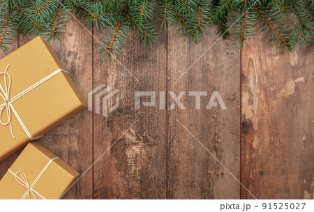 Christmas composition. Christmas gift, fir branches on wooden rustic background. Beautiful Christmas composition with handmade gifts crafting on a rustic dark wooden. Flat lay, copy space Christmas composition. Christmas gift, fir branches on wooden rustic background. Beautiful Christmas composition with handmade gifts crafting on a rustic dark wooden. Flat lay, copy space 91525027