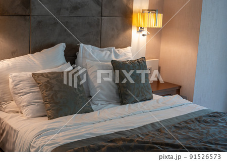 made bed. Modern and Neat Bed at Night. Elegant double bed. close-up of a made-up bed in a hotel room. made bed. Modern and Neat Bed at Night. Elegant double bed. close-up of a made-up bed in a hotel room. 91526573