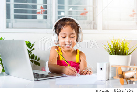 Asian child girl studying video conference distant education at home 91527256