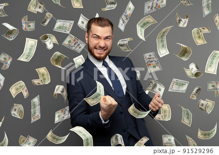 Businessman standing in the rain of money Businessman standing in the rain of money 91529296