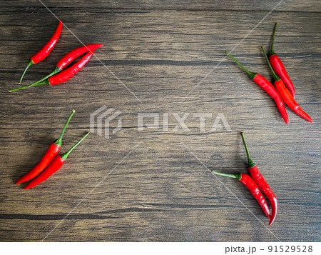 Fresh red chili and space for text on wooden background Fresh red chili and space for text on wooden background 91529528