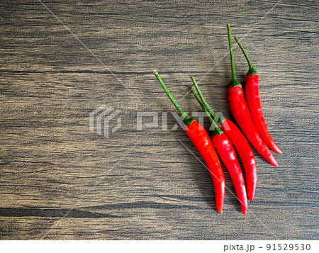 Fresh red chili and space for text on wooden background Fresh red chili and space for text on wooden background 91529530