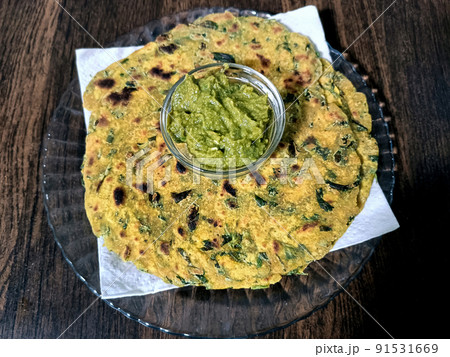 Palak paratha or Indian flat breads made from spinach and served with mango pickle and mint dip, Indian breakfast 91531669