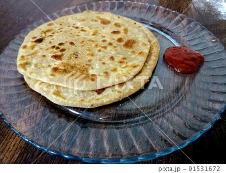 Aloo parantha an ideal indian breakfast served with tomato sauce 91531672