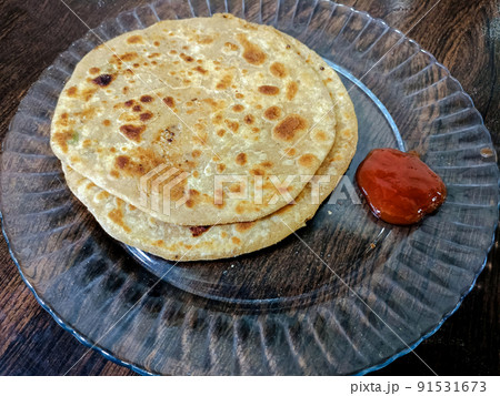 Poori an ideal indian breakfast served with tomato sauce 91531673