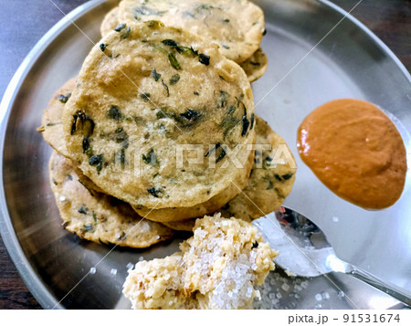 Poori an ideal indian breakfast served with tomato sauce 91531674