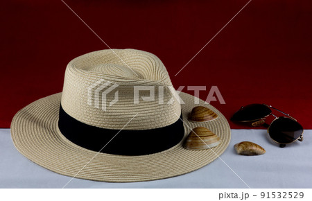 Panama Hat with Sunglasses and Sea Shells on Red and White Panama Hat with Sunglasses and Sea Shells on Red and White 91532529