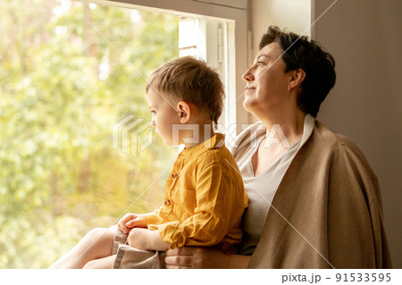 Happy grandmother and grandson enjoy time together. Positive middle age woman spending time with little, cute grandchild. 50-year-old grandma with grandkid. Multi-generational family. Happy grandmother and grandson enjoy time together. Positive middle age woman spending time with little, cute grandchild. 50-year-old grandma with grandkid. Multi-generational family. 91533595