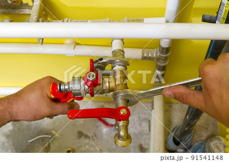 connecting plumbing fittings with keys. The plumber assembles a new water connection to the sink. connecting plumbing fittings with keys. The plumber assembles a new water connection to the sink. 91541148