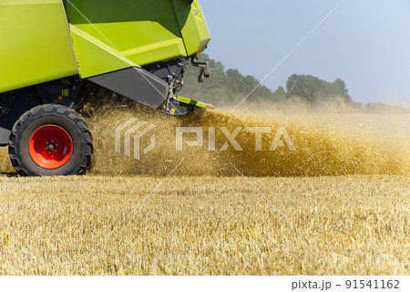 harvester in work at summer hot day , blured - out of focus. 91541162