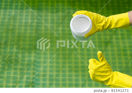 addition of chlorine powder for the pool to remove algae and disinfect water. inflatable swimming pool care concept. 91541271