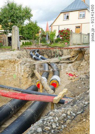 underground heating system pipes replacement on the city street among the houses. underground heating system pipes replacement on the city street among the houses. 91541400