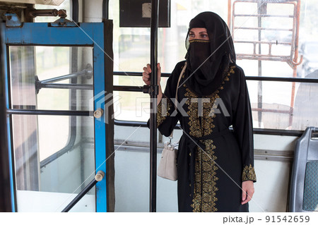 Muslim woman in public transport going to work 91542659