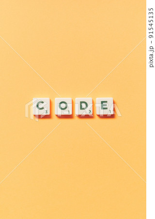 Code formed of scrabble blocks on yellow background. Code formed of scrabble blocks on yellow background. 91545135