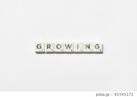 Growing formed of scrabble blocks on white background. Growing formed of scrabble blocks on white background. 91545172