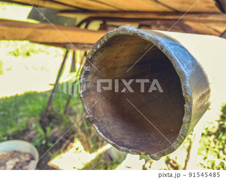 old, rusty pipe in a car for exhaust gases. exhaust port. road parts. repair of old cars at their summer cottage against the backdrop of nature 91545485