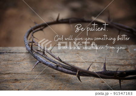 Christian prayer quote - Be patient. God will give you something better that what was taken from you. With crown thorns and old wooden block background. Christianity concept 91547163