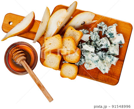 Roncari blue cheese with pear, toasts and honey on wooden board Roncari blue cheese with pear, toasts and honey on wooden board 91548996